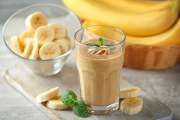 Fresh banana cocktail with peanuts on cutting board