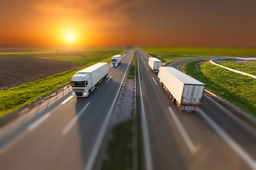 Tilt shift image of delivery trucks on the highway