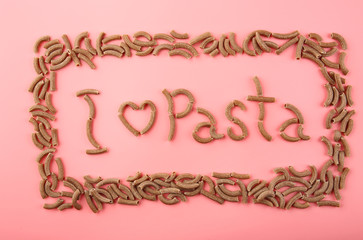 I love pasta inscription made with brown macaroni on pink background