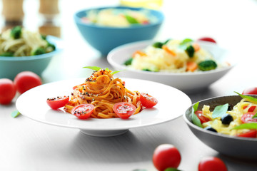 Different cold pasta salads in bowls on the table closeup