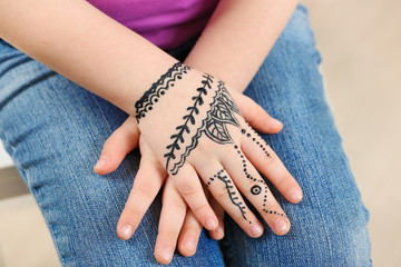 Henna ornaments on girl's hand closeup