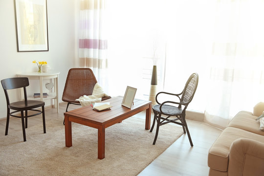 Modern living room interior. Different kinds of chair around table.