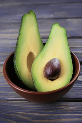 Fresh avocado in bowl on wooden table © Africa Studio