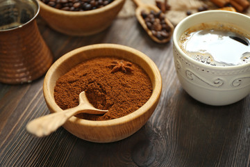 Coffee with beans and spices on wooden table closeup