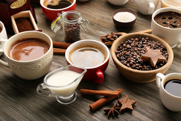 Delicious fresh coffee with spices on wooden table closeup