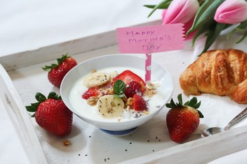 Mother's day breakfast or Brunch / Breakfast yogurt bowl with berries and croissant