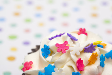cropped image of a cupcake with floral pattern icing.
