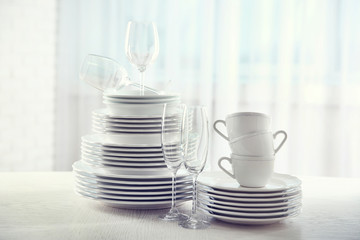 Set of new white dishes on wooden table, indoors