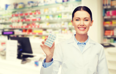 woman pharmacist with pills drugstore or pharmacy