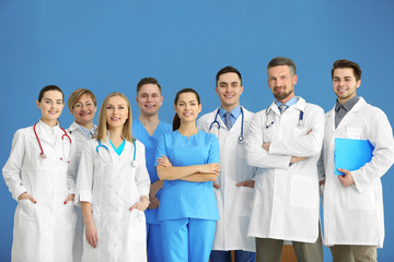 A group of doctors and nurses standing in the hospital, indoors