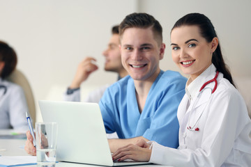 Fototapeta premium Medical doctors sitting at the meeting in modern hospital