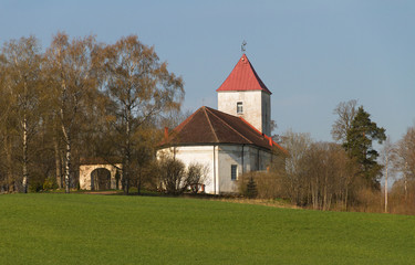 Fototapeta na wymiar Small church on a field.