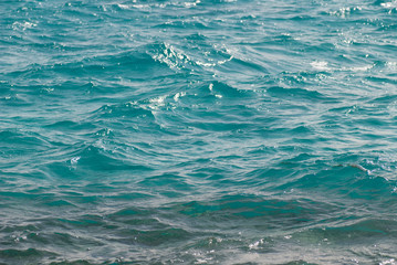 Photo closeup of beautiful clear turquoise sea ocean water surface with ripples low waves on seascape background, horizontal picture