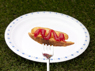 potato strip in a fork with white plate