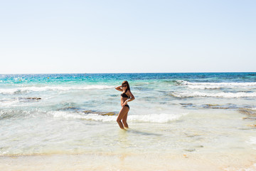 young beautiful  girl in swimsuit bikini posing on beach, fashion model, fitness figure.