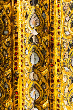 Golden mosaic ornament on the wall of a Buddhist temple in Bangk