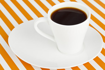 a mug of dark coffee on a saucer