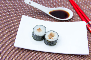 Maki with tuna on a placemat bamboo seen up close