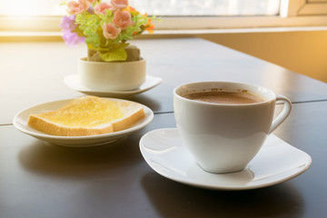 cup of coffee toast with butter. Morning light