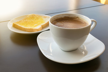 cup of coffee toast with butter. Morning light