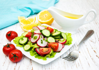 Spring salad with tomato, cucumbers and radish