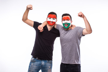 Austria vs Hungary on white background. Football fans of national teams celebrate, dance and scream. European football fans concept.