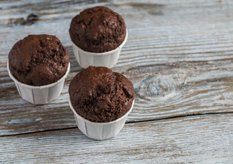 Chocolate muffins on a blue wooden background