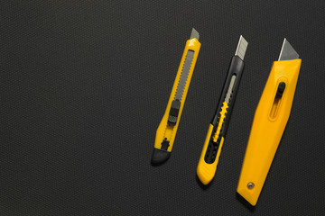 Paper cutter, office equipment, box cutter isolated against a bl