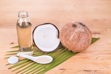 Cold pressed extra virgin coconut oil in one bottle with coconut fruits 