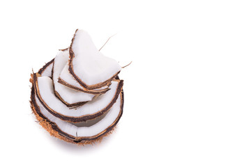Old brown organic coconut fruit broken into pieces and stacked