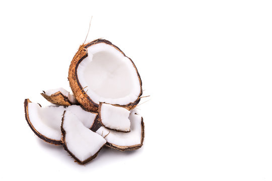 Old brown organic coconut fruit broken into pieces