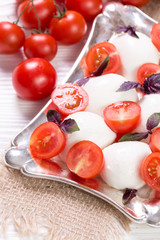 mozzarella, cherry tomatoes and fresh basil - ingredients for caprese salad