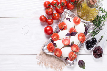 Naklejka na ściany i meble mozzarella, cherry tomatoes and fresh basil - ingredients for caprese salad