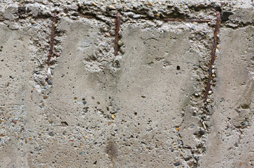 old concrete wall with reinforcement bars