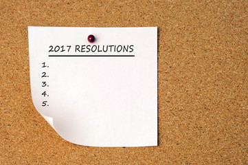 Black 2017 new year's resolutions pin on a cork board