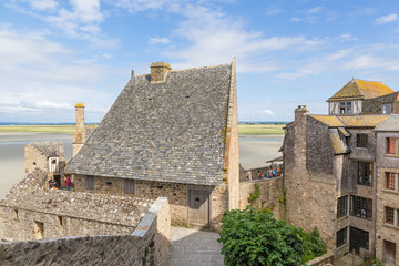 Fototapeta na wymiar Mont-St-Michel, France. Ancient building of the abbey behind the ramparts