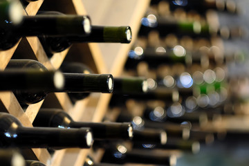 Wine bottles stacked on wooden racks - 109630306