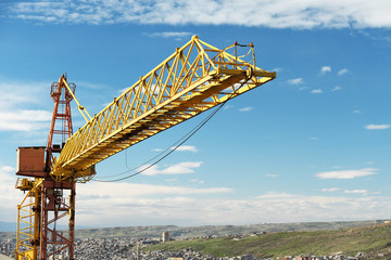 Fototapeta na wymiar Crane tower against a blue sky