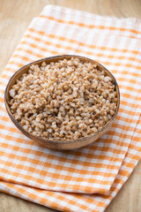Buckwheat porridge in a bowl with mint leaves and blueberries.
