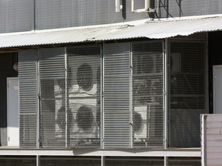 Fototapeta premium Many air conditioners at the shopping center. The ventilation system of protective netting.