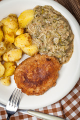 Delicious meal of minced meat cutlet, potatoes and fried cabbage