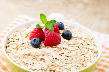 Oatmeal porridge with berries. Raspberries and blueberries.