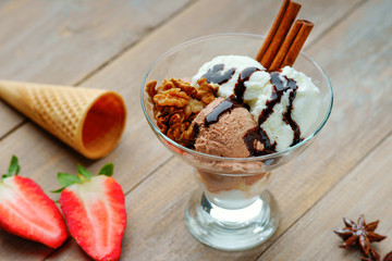Ice cream sundae, waffle cone and sliced strawberry