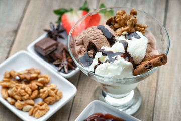 Ice cream sundae, chocolate, walnuts and sliced strawberry