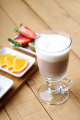 Coffee latte and sliced fruits