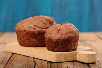 Pair of homemade chocolate cakes on blue background
