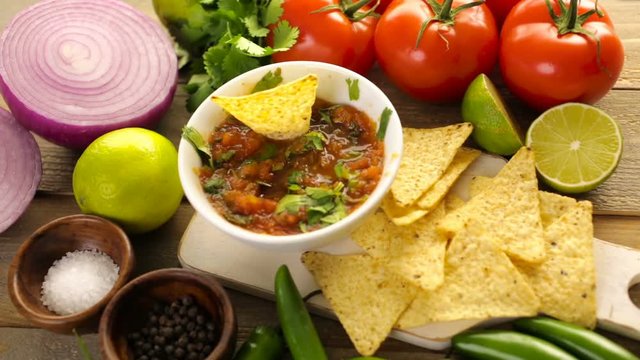 Fresh salsa in white bowl with ingredients