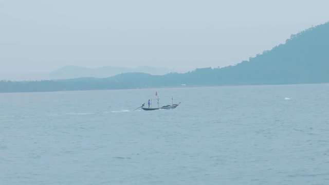 Single fishing boat on the beach. Beautiful shot zoom in .Thailand
