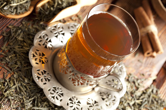 Glass of tea and dried tea leaves