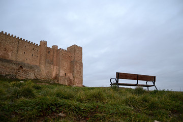 bench near a castle, cloudy day. Sigüenza castle, Spain